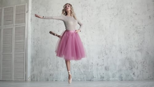 Elegant Ballerina Dancing Gracefully in a Bright Studio