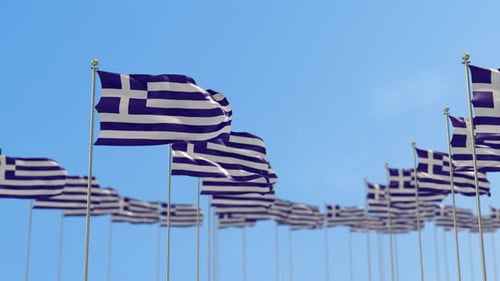 Many Greek National Flags Waving Proudly Against a Clear Blue Sky