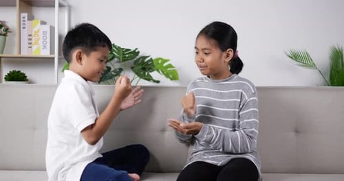 The children play Hand game with Rock–paper–scissors at home