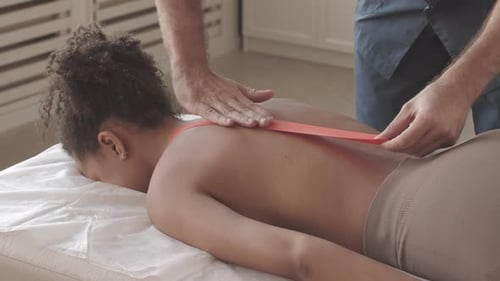 Therapeutic Tape Applied to Back on Massage Table