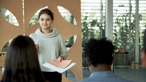Woman Leading a Meeting in Modern Workplace