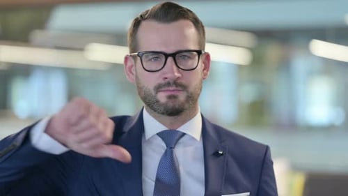 Portrait of Thumbs Down Gesture By Middle Aged Businessman