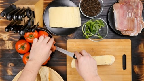 Preparing Delicious Bruschetta with Cheese, Tomato and Prosciutto