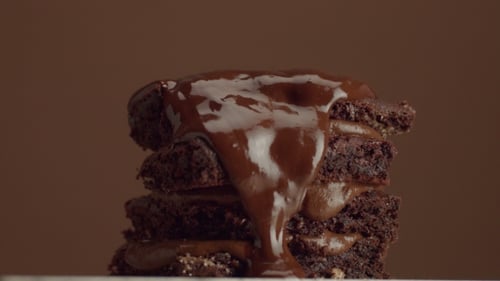Chocolate Brownies Stacked with Chocolate Sauce Drizzled on Top