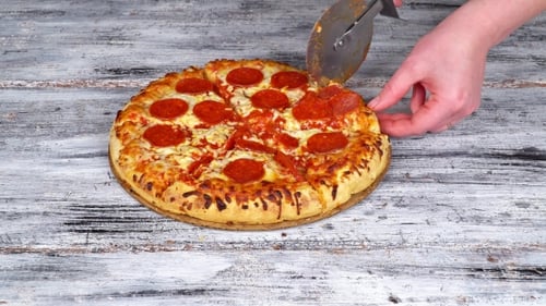 Cutting Pepperoni Pizza with a Pizza Cutter