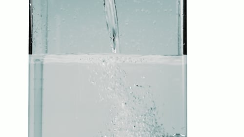 Clear Water Pouring Into Glass With Bubbles