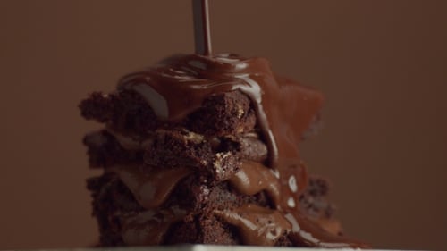 Chocolate Sauce Poured on Stacked Brownie Dessert