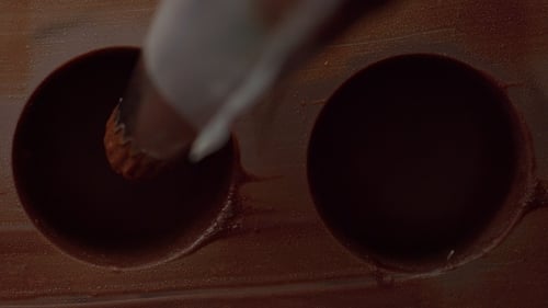 Chocolate Cream Being Piped into Molds for Dessert