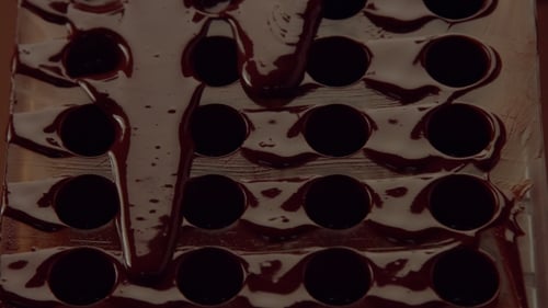 Dark Chocolate Filling a Candy Mold