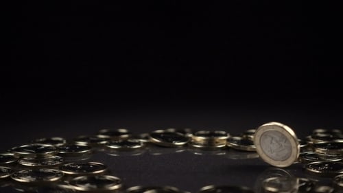Eine Euro-Münze dreht sich auf schwarzem Hintergrund