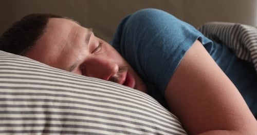 Man Sleeping in Bed