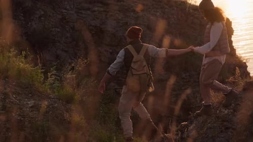 Couple Hiking Hand-in-Hand at Sunset