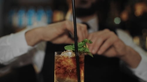 Bartender Garnish Cocktail With Lemon Twist Close Up