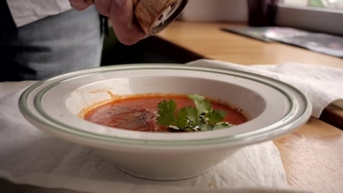 Tomato Soup Bowl of Vegetable Soup in Modern Cafe Pepper Hands Spoon