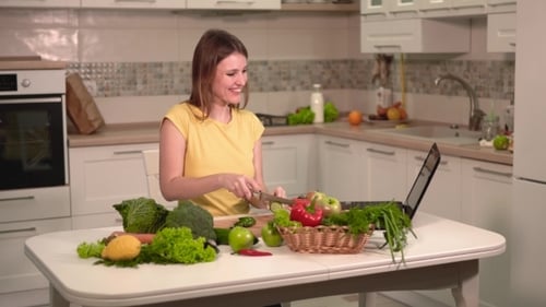 Woman Chopping Vegetables in Kitchen, Video Call