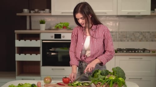Woman Preparing Fresh Vegetables in Bright Kitchen