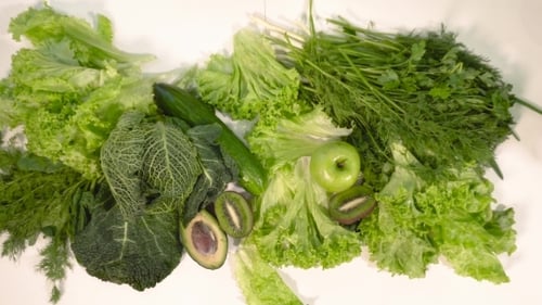 Putting Green Fruit and Vegetables on Table