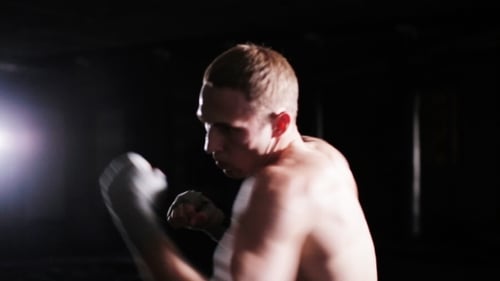 Male Boxer Punches In Boxing Gym