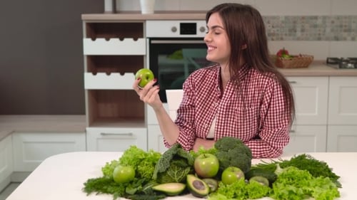 Young Woman Enjoys Healthy Green Produce in Kitchen