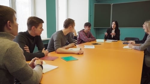 Group Meeting Around Table in Classroom Setting
