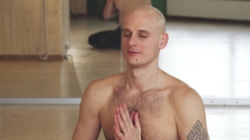 Man Meditates In Seated Yoga Position