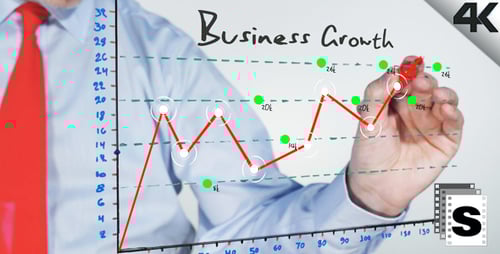Man Draws Business Growth Graph with Red Marker