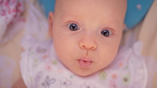 Cute Three Months Baby Girl with Big Blue Eyes