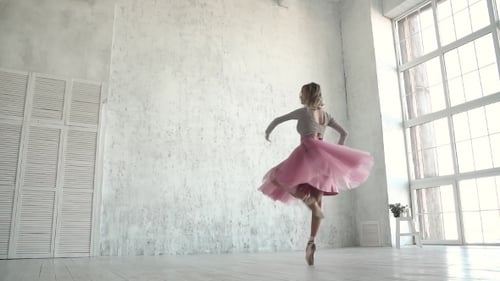 Elegant Ballerina Dancing Ballet in Bright Studio