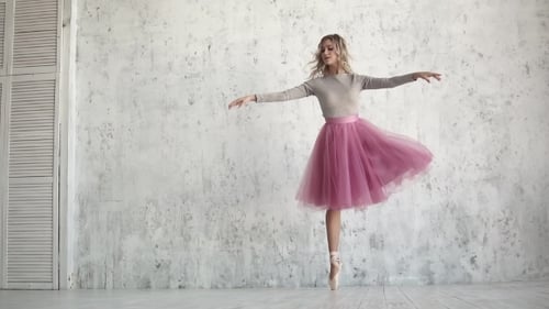 Elegant Ballerina Practices Graceful Ballet Dance in Studio