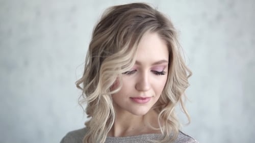 Attractive Blonde Woman with Wavy Hair Posing