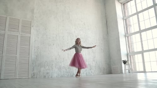 Ballerina Performing Pirouettes in Studio. Ballet Dancer in a Classic Tutu and Pointe