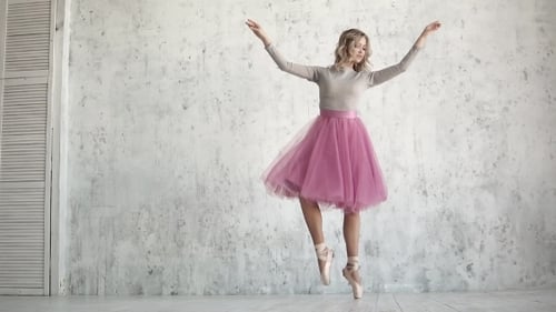 Woman Performing Ballet Moves in Bright Studio