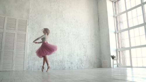 Graceful Woman Performs Ballet Dance in Bright Studio