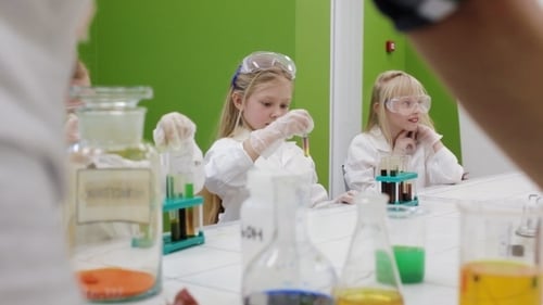 Children Conduct Science Experiment in Bright Classroom