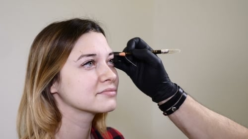 Woman Getting Eyebrow Shaping Beauty Procedure