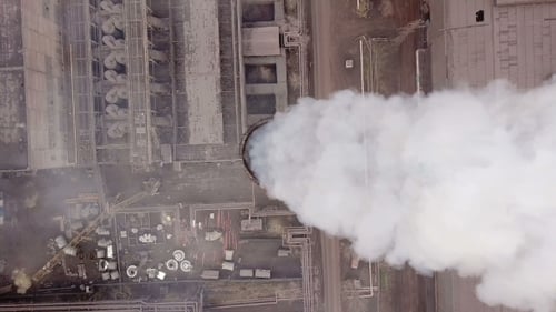 Industrial Smokestack Emitting White Smoke Aerial View