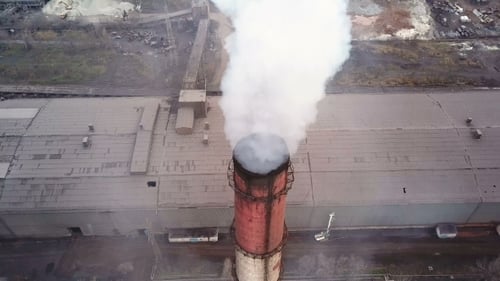 Aerial View. Emission To Atmosphere From Industrial Pipes. Smokestack Pipes Shooted with Drone. .