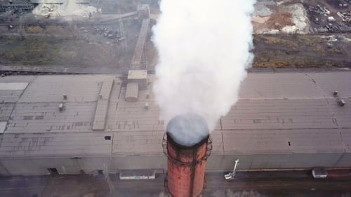 Aerial View. Emission To Atmosphere From Industrial Pipes Smokestack Pipes Shooted with Drone