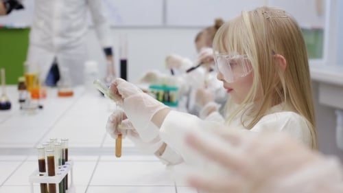 Children in Science Class Perform Chemical Experiment