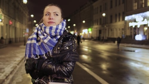 Young Girl Feels Herself Cold During Waiting Friends at the Urban Street