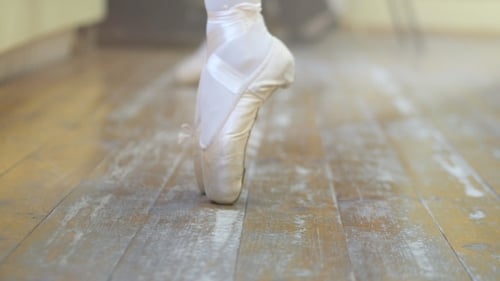 A Ballerina Shows a Classic Warm-up. Close the Ballerina's Feet When She Practiced the Exercises