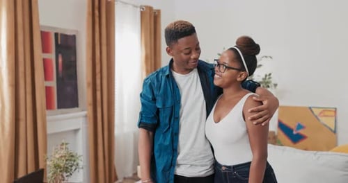 A Couple in Love Moves Into a New Apartment Cardboard Boxes with Packed Things Stand in the Living