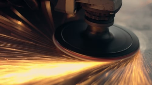 Worker Using Industrial Grinder