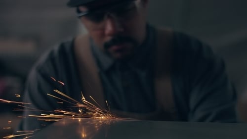 Worker Using Industrial Grinder
