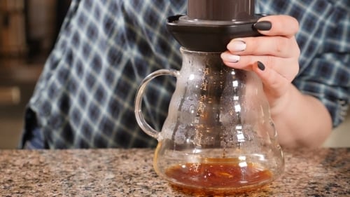 Filtered Coffee Dripping into Glass Carafe at Home