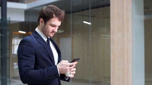 Handsome Businessman Using Smartphone in The Office