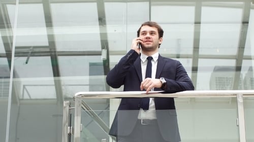Man Speaking on Cell Phone in Modern Office