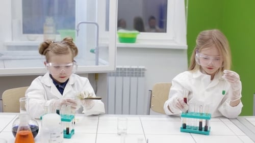 Young Girls Conducting Science Experiment in Laboratory