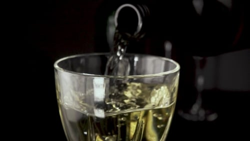 Pouring Golden Liquid into a Glass