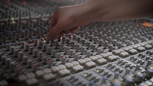 Hand Adjusting Audio Mixing Board Slider